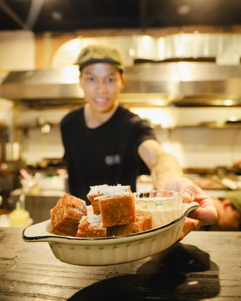 1000 layer potato bites served in a fluted dish at the pass